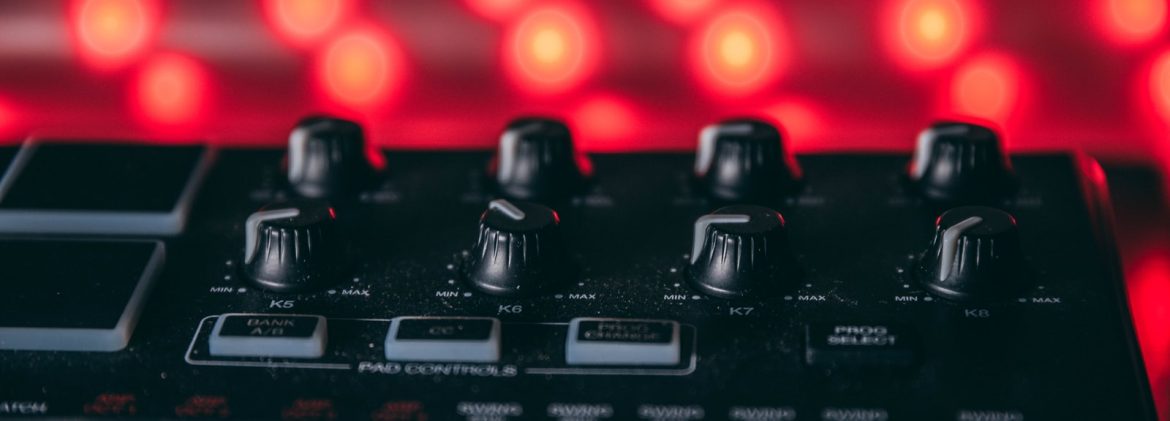 black audio mixer turned on with red lights